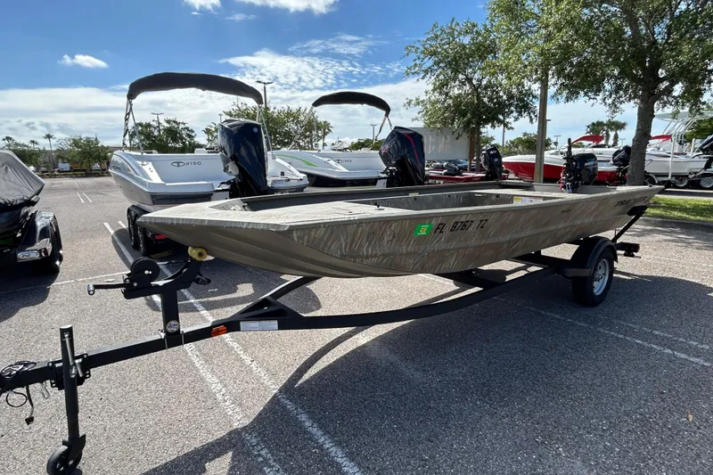 Slide: The Image of 2025 Tracker Grizzly 1754 Jon boat on trailer in sunny parking lot. - 3