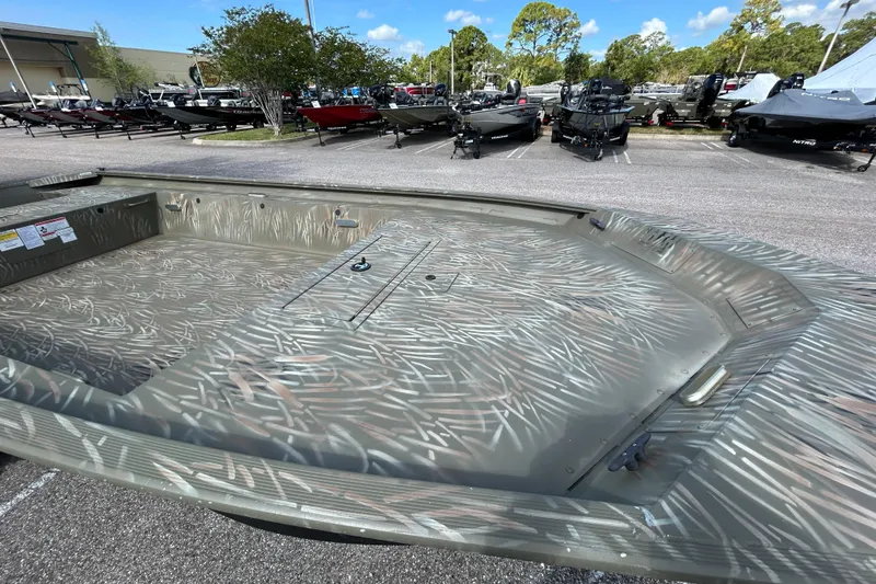 Slide: The Image of 2025 Tracker Grizzly 1754 Jon boat with camouflage pattern in a dealership lot. - 5