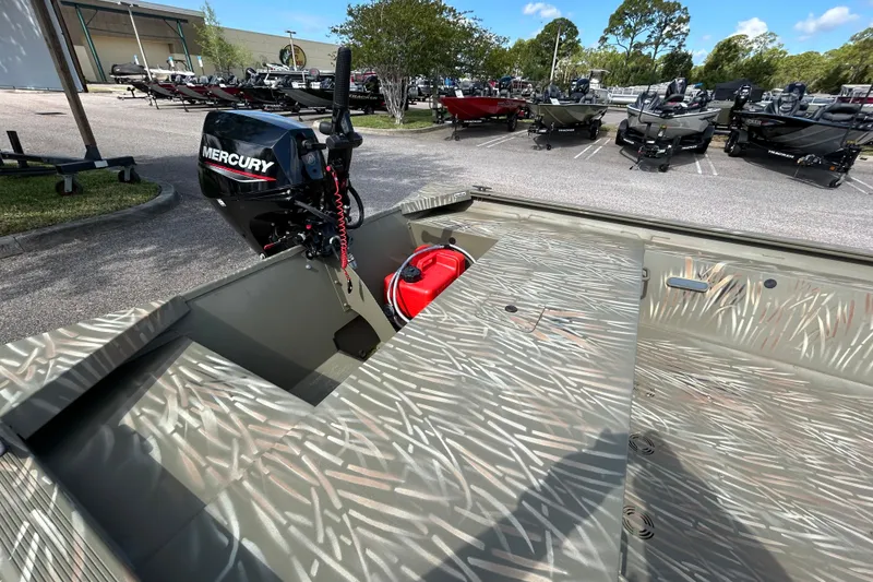 Slide: The Image of 2025 Tracker Grizzly 1754 Jon boat with Mercury outboard motor in a dealership lot. - 6