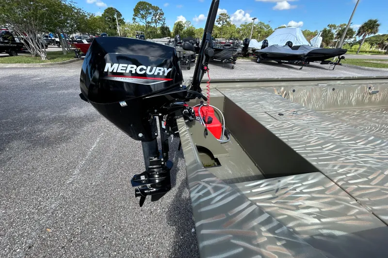 Slide: The Image of 2025 Tracker Grizzly 1754 Jon boat with Mercury outboard motor in parking lot. - 7