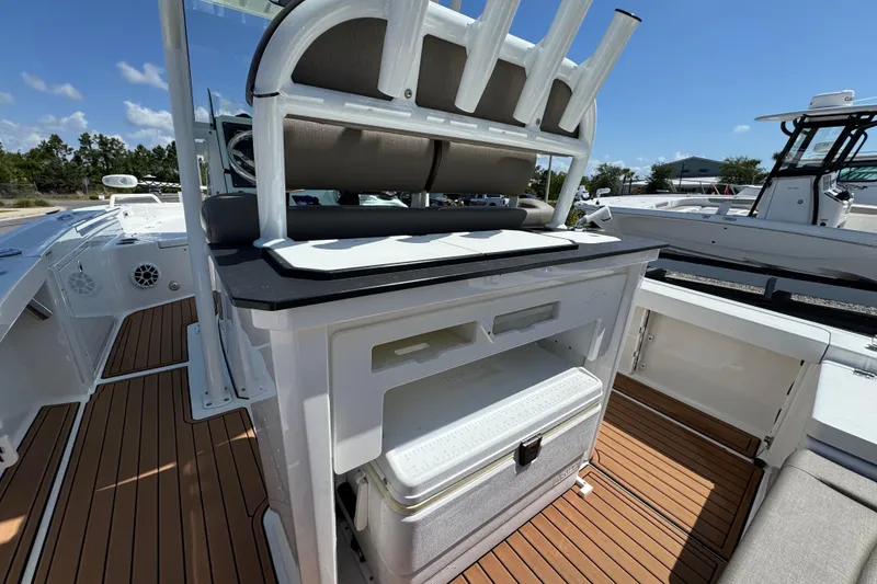 Slide: The Image of 2020 Crevalle 24 HCO boat interior with seating and storage, featuring teak flooring. - 13