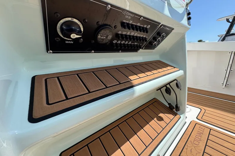 Slide: The Image of 2020 Crevalle 24 HCO boat console with control panel and teak-style steps. - 18