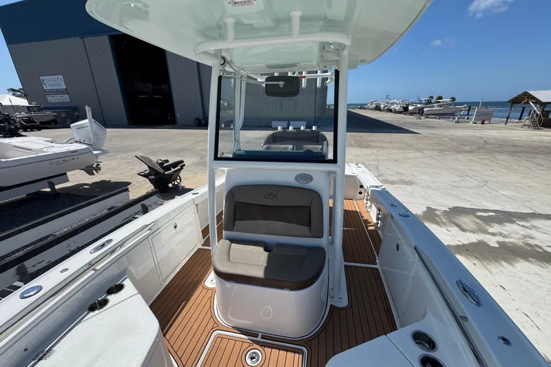 Slide: The Image of 2020 Crevalle 24 HCO boat with sleek interior, docked near a marina. - 22