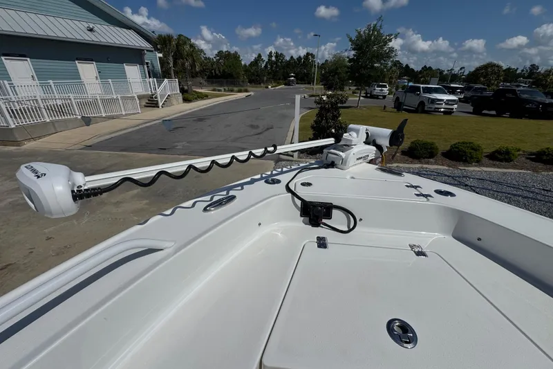 Slide: The Image of 2020 Crevalle 24 HCO boat with trolling motor in a parking lot. - 25