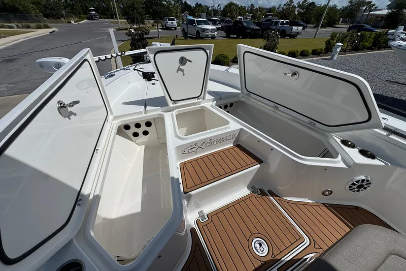 Slide: The Image of 2020 Crevalle 24 HCO boat interior with open storage compartments and teak flooring. - 26