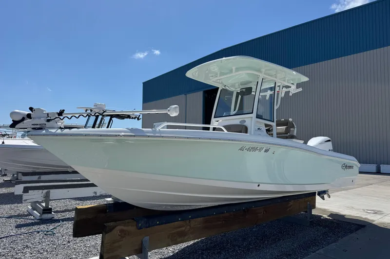 Slide: The Image of 2020 Crevalle 24 HCO boat on display outside a blue warehouse. - 7