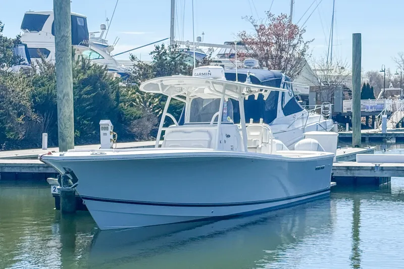 The Image of 2017 Regulator 31 boat docked in a marina, clear sky background. - 0