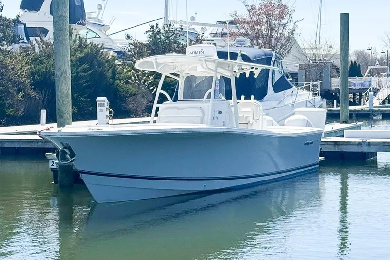The Image of 2017 Regulator 31 boat docked in a marina, featuring sleek design and modern equipment. - 1