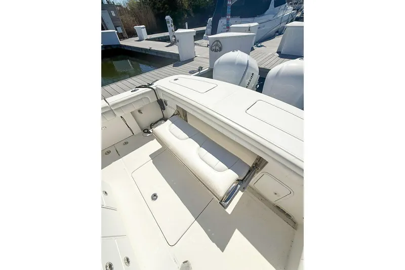 Slide: The Image of 2017 Regulator 31 boat with foldable seating and Yamaha engines at dock. - 10