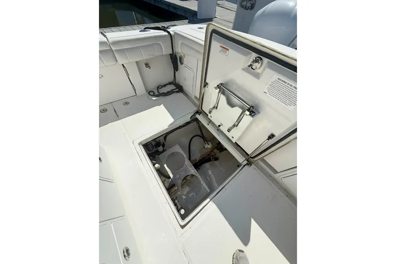 Slide: The Image of Open hatch on 2017 Regulator 31 boat, revealing storage compartment. - 11