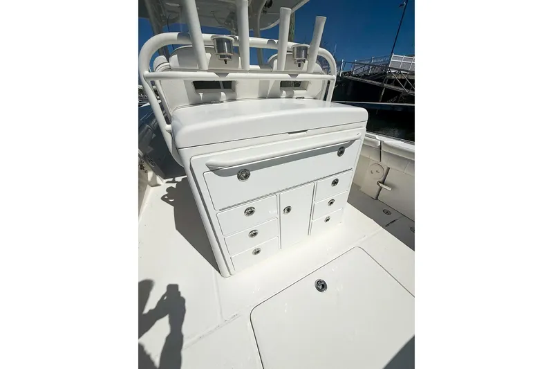Slide: The Image of 2017 Regulator 31 boat interior with storage compartments and rod holders. - 12