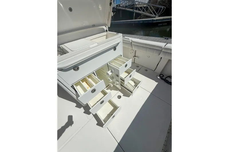 Slide: The Image of 2017 Regulator 31 boat with open storage compartments and drawers on deck. - 14