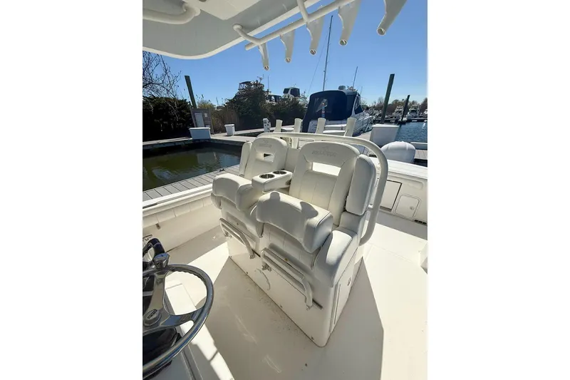 Slide: The Image of 2017 Regulator 31 boat with dual white captain's chairs, docked at a marina. - 16