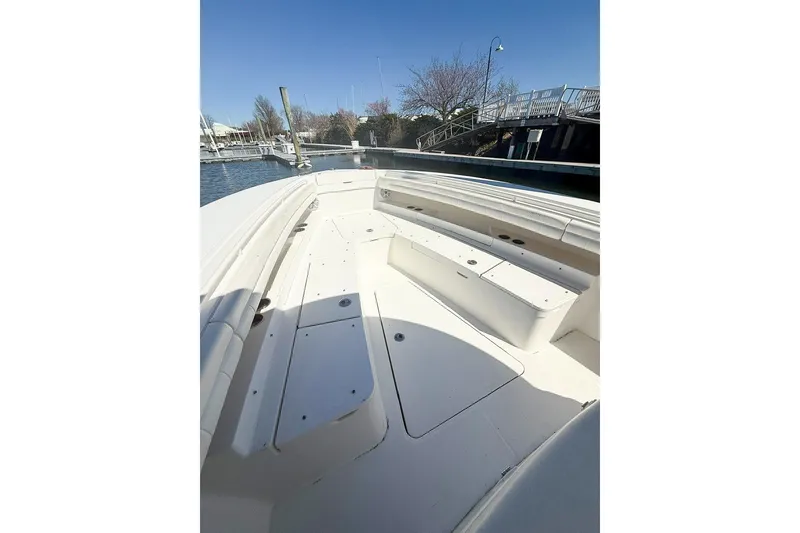 Slide: The Image of 2017 Regulator 31 boat with spacious seating, docked in a serene marina setting. - 18
