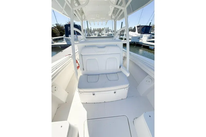 Slide: The Image of 2017 Regulator 31 boat interior with white seating and marina background. - 19