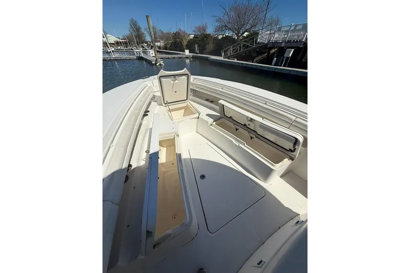 Slide: The Image of 2017 Regulator 31 boat interior with open storage compartments at a marina. - 21
