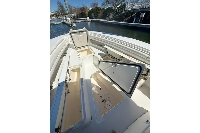 Slide: The Image of 2017 Regulator 31 boat with open storage compartments at a marina. - 22