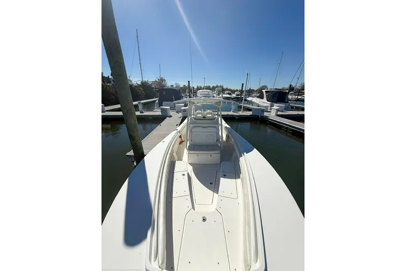 Slide: The Image of 2017 Regulator 31 boat docked at marina under clear blue sky. - 25