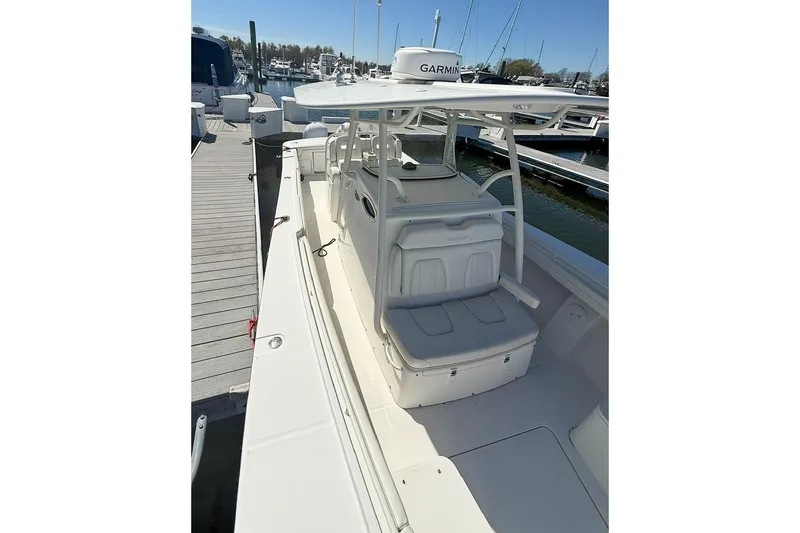Slide: The Image of 2017 Regulator 31 boat docked, featuring spacious seating and Garmin navigation system. - 26