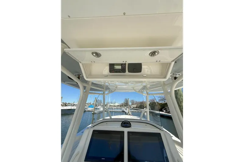 Slide: The Image of 2017 Regulator 31 boat helm with navigation screens and overhead console. - 29