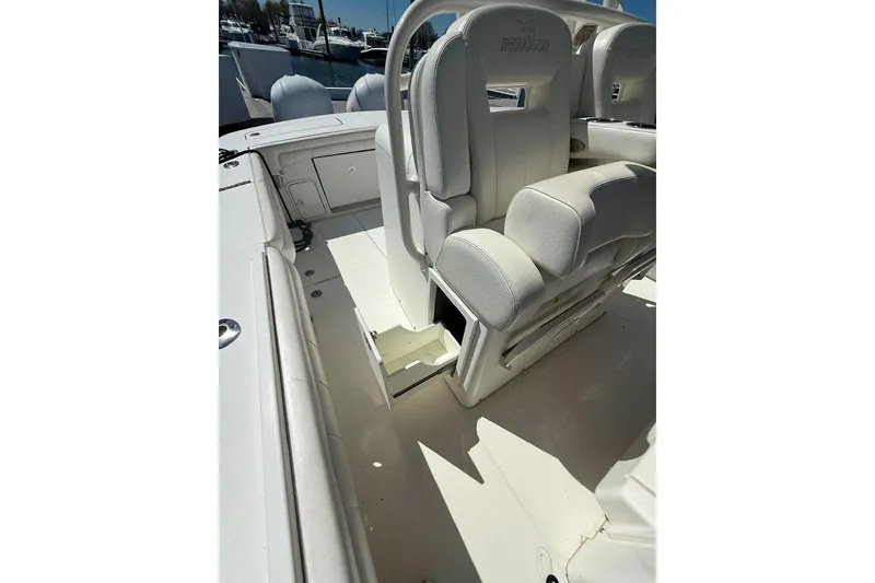 Slide: The Image of 2017 Regulator 31 boat interior with white cushioned seating and storage compartments. - 30