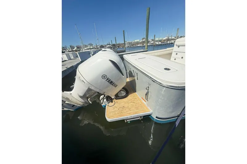 Slide: The Image of 2017 Regulator 31 boat with Yamaha outboard motor docked at marina. - 31