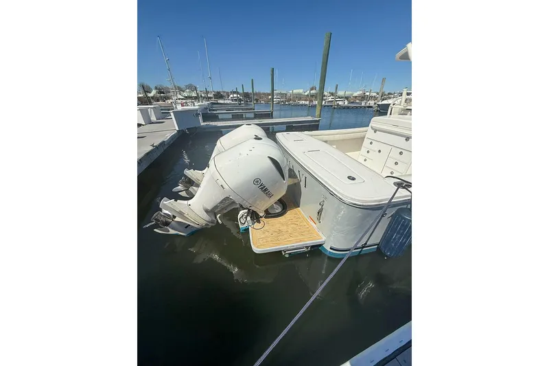 Slide: The Image of 2017 Regulator 31 boat with Yamaha outboard engines docked at marina. - 32