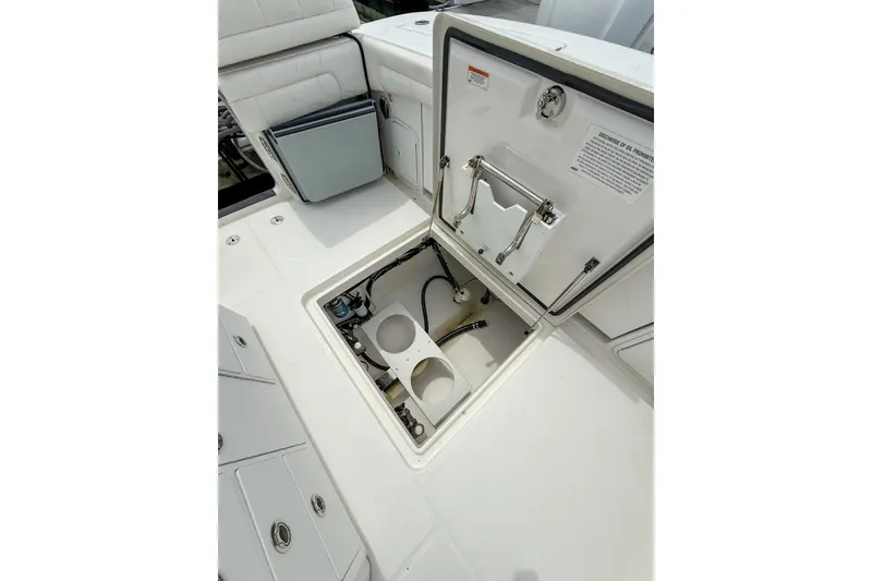 Slide: The Image of 2017 Regulator 31 boat storage compartment with open hatch and visible interior components. - 33