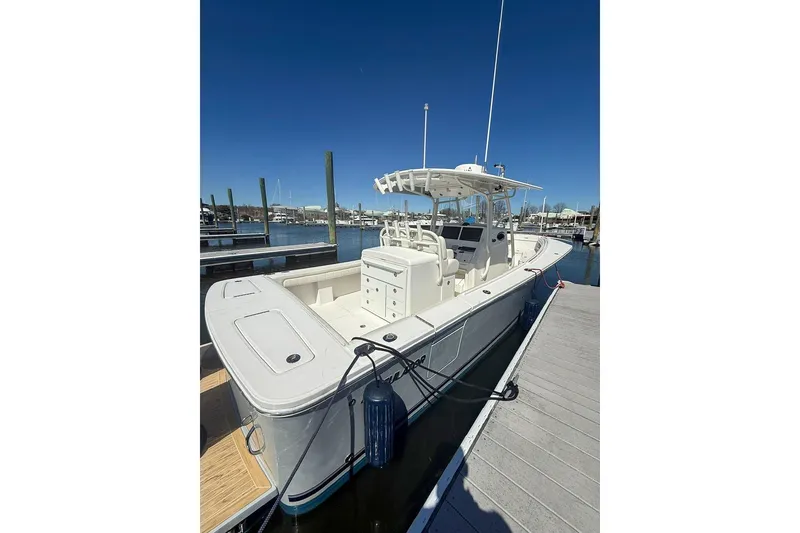 Slide: The Image of 2017 Regulator 31 boat docked at marina under clear blue sky. - 5