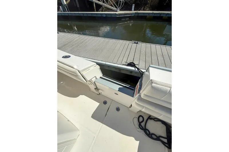 Slide: The Image of 2017 Regulator 31 boat interior with open hatch, docked by the water. - 6
