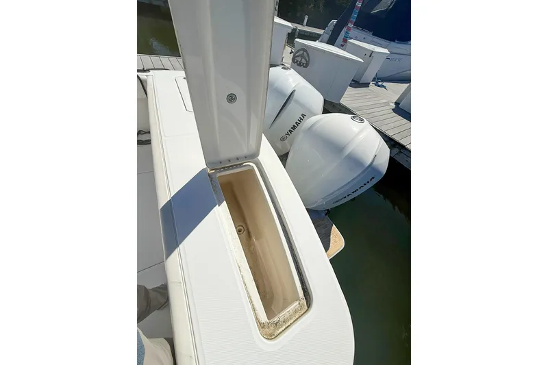 Slide: The Image of 2017 Regulator 31 boat with Yamaha engines, open storage compartment, docked at marina. - 8