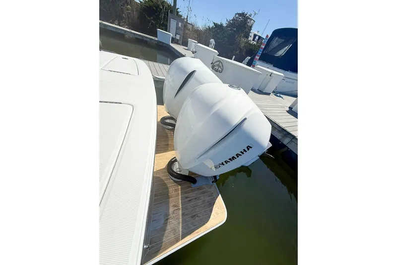 Slide: The Image of 2017 Regulator 31 boat with twin Yamaha outboard engines docked at marina. - 9
