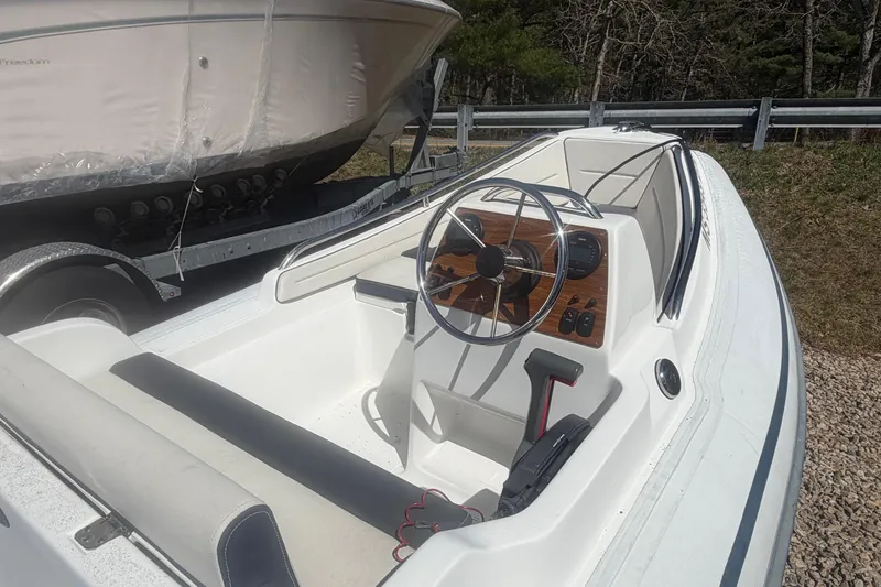 Slide: The Image of 2018 AB Inflatables Nautilus 12 DLX boat interior with steering wheel and controls. - 4