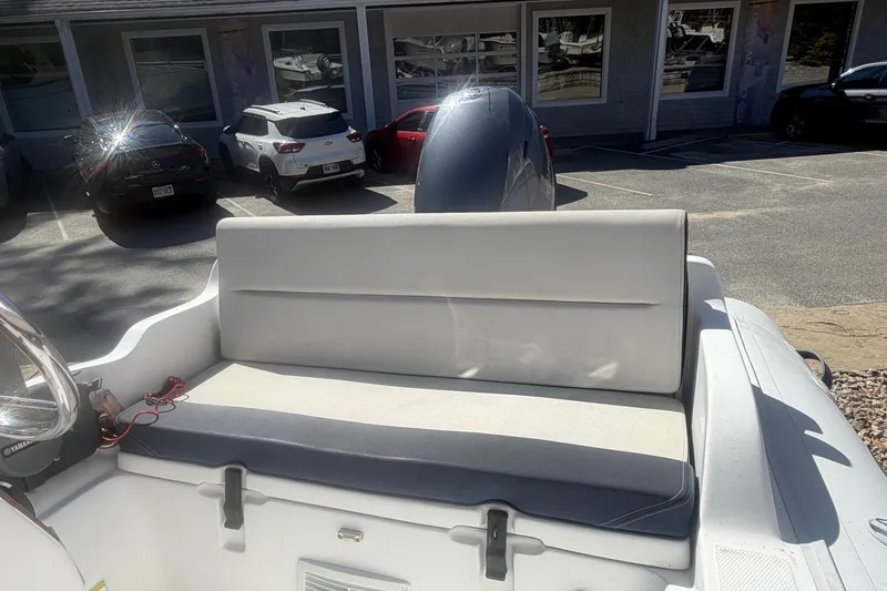 Slide: The Image of 2018 AB Inflatables Nautilus 12 DLX boat interior with cushioned seating and parked cars in background. - 5