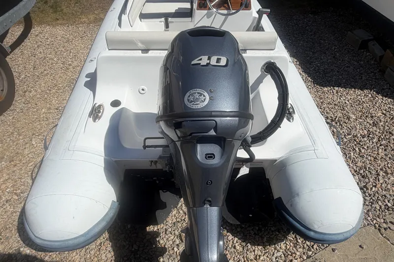 Slide: The Image of 2018 AB Inflatables Nautilus 12 DLX with Yamaha 40HP engine, parked on gravel. - 6