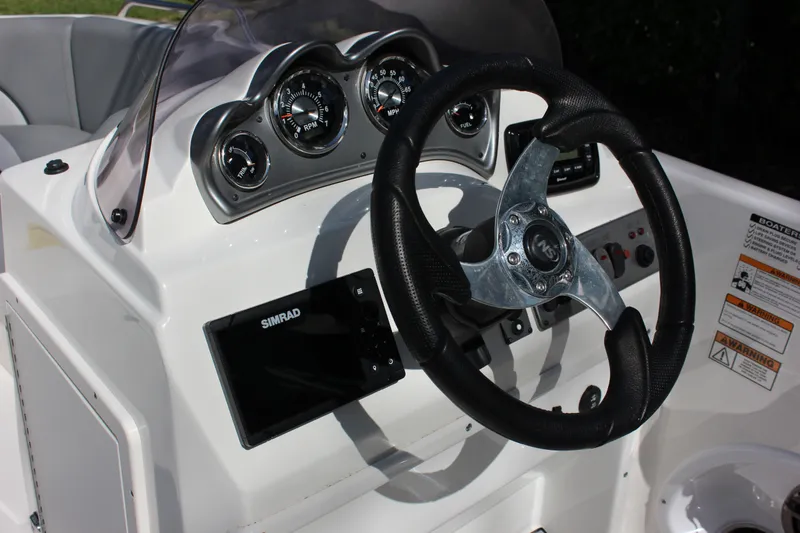 Slide: The Image of NauticStar 203 SC 2022 helm with steering wheel and gauges. - 12