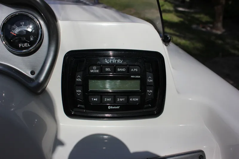 Slide: The Image of NauticStar 203 SC 2022 boat console with Infinity radio and fuel gauge. - 13