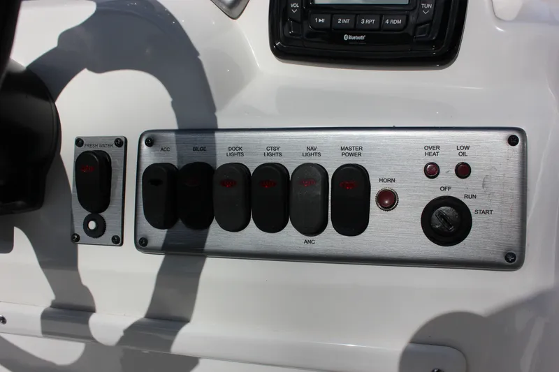 Slide: The Image of Dashboard of 2022 NauticStar 203 SC with switches and indicators. - 15