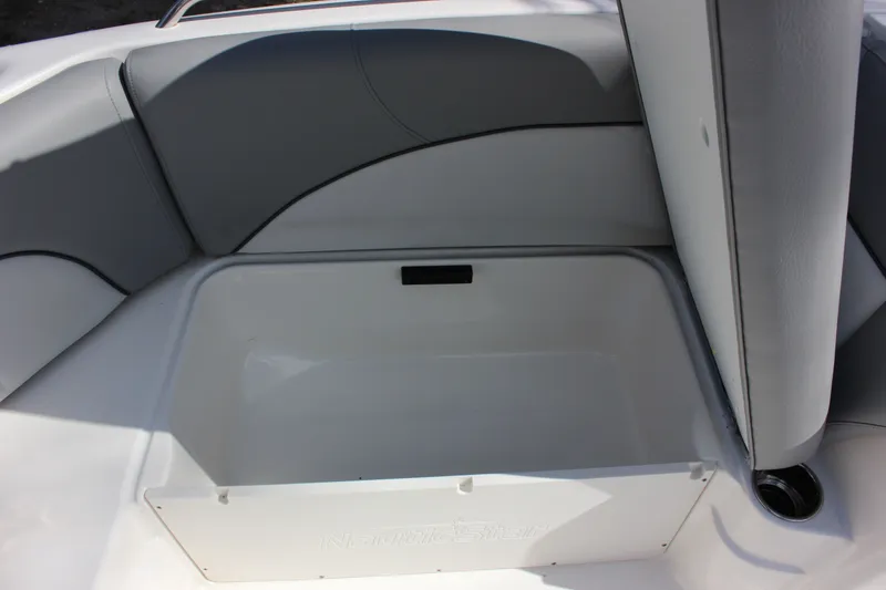 Slide: The Image of NauticStar 203 SC 2022 boat with open storage compartment. - 21