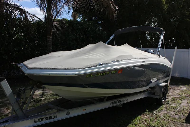 Slide: The Image of 2022 NauticStar 203 SC boat covered on trailer. - 28