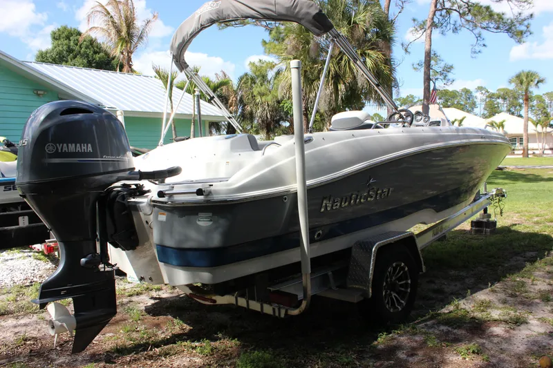 Slide: The Image of 2022 NauticStar 203 SC boat with Yamaha engine parked outdoors. - 4