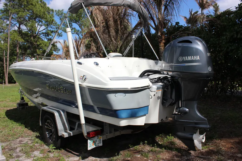 Slide: The Image of 2022 NauticStar 203 SC boat with Yamaha engine outdoors. - 5