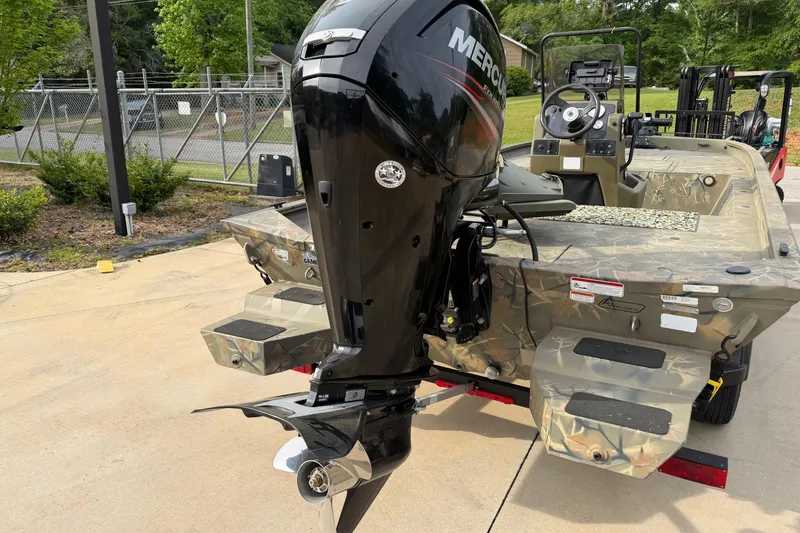Slide: The Image of 2019 Tracker Grizzly 1860 CC Sportsman boat with Mercury outboard motor, parked outdoors. - 3