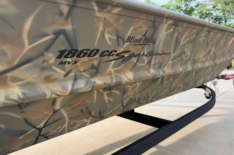 Slide: The Image of 2019 Tracker Grizzly 1860 CC Sportsman boat with camouflage design on trailer. - 4