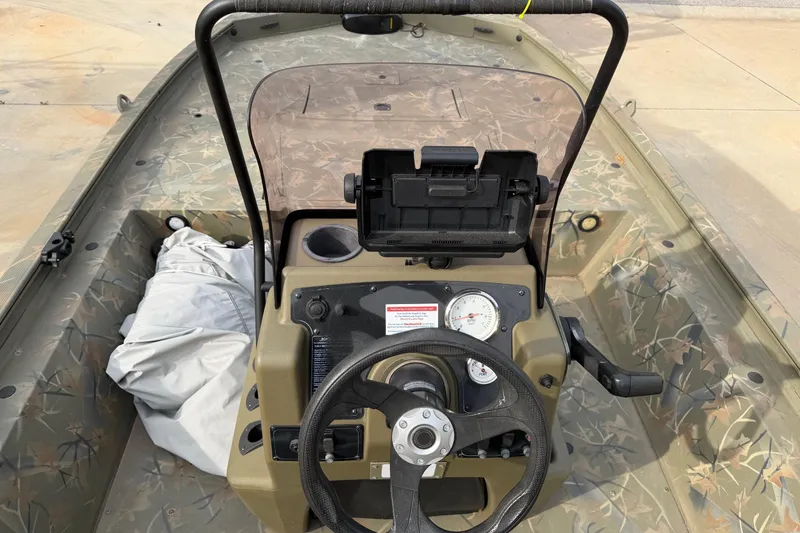 Slide: The Image of 2019 Tracker Grizzly 1860 CC Sportsman boat interior with steering wheel and control panel. - 6