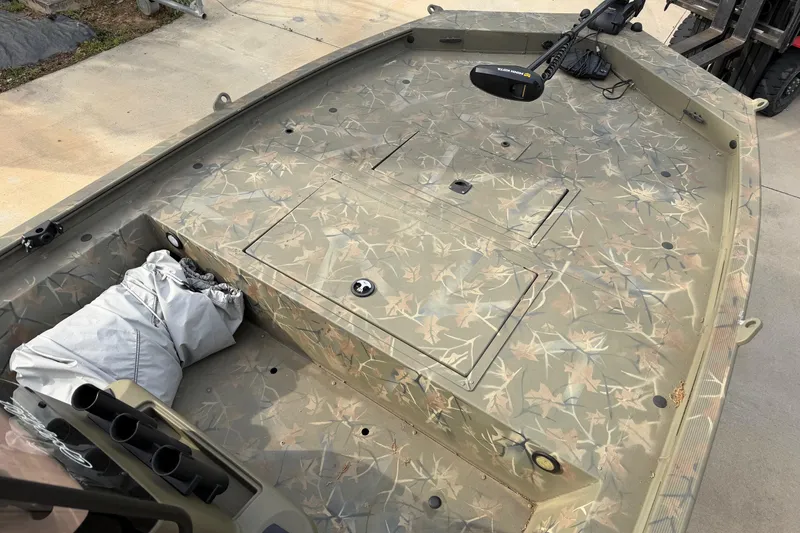 Slide: The Image of 2019 Tracker Grizzly 1860 CC Sportsman boat with camouflage deck and trolling motor. - 8