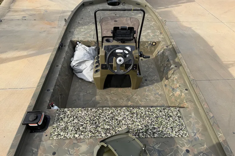 Slide: The Image of 2019 Tracker Grizzly 1860 CC Sportsman boat interior with camouflage design and steering console. - 9