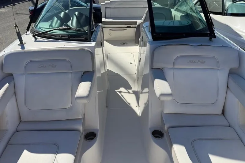 Slide: The Image of 2012 Sea Ray 260 Sundeck boat interior with white seating and windshield. - 10