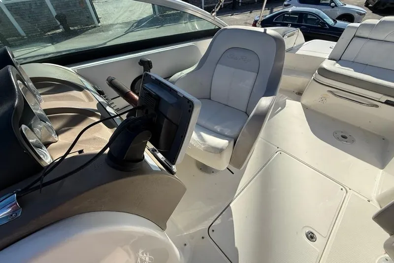 Slide: The Image of 2012 Sea Ray 260 Sundeck interior with helm, seating, and dashboard controls. - 11