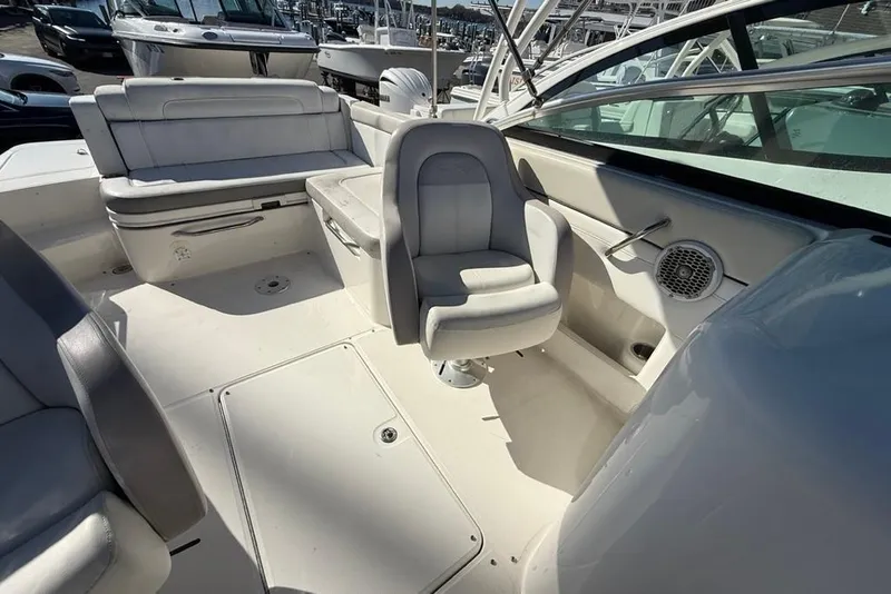 Slide: The Image of 2012 Sea Ray 260 Sundeck interior with white seating and steering area. - 12